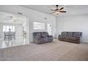 Spacious living room with neutral carpeting and two sofas at 19607 N Conquistador Dr, Sun City West, AZ 85375