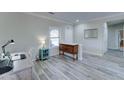 Entryway with wood-look floors, half wall, and built-in shelving at 20055 N Siesta Rock Dr, Surprise, AZ 85374