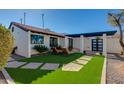 Landscaped front yard with artificial turf and brick walkways at 2039 E Aspen Dr, Tempe, AZ 85282