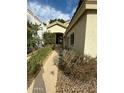 Home's entrance with a walkway and lush landscaping at 2322 S Rogers -- # 9, Mesa, AZ 85202