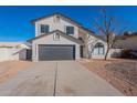 Two story home with gray garage door and landscaped yard at 2513 N 90Th Ln, Phoenix, AZ 85037