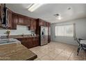 Kitchen features stainless steel refrigerator and granite countertops at 2738 N 40Th Dr, Phoenix, AZ 85009