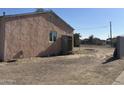 Side view of the house, showing a window and door at 3143 W Garfield St, Phoenix, AZ 85009