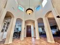 Grand entry with high ceilings, tiled floors, and views to living areas at 3199 N 159Th Dr, Goodyear, AZ 85395