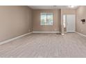 Empty living room with light wood-look floors at 39979 W Robbins Dr, Maricopa, AZ 85138