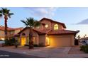 Two-story house with Spanish-style architecture and a landscaped yard at 4407 E Villa Theresa Dr, Phoenix, AZ 85032