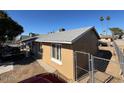 Side view of tan house, fenced yard at 4854 W Berkeley Rd, Phoenix, AZ 85035