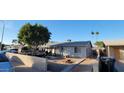 House with large tree and spacious front yard at 4854 W Berkeley Rd, Phoenix, AZ 85035