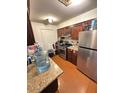 Bright kitchen features granite countertops and dark wood cabinets at 4854 W Berkeley Rd, Phoenix, AZ 85035