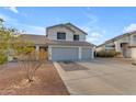 Two-story house with gray garage doors and a landscaped front yard at 5429 W Kerry Ln, Glendale, AZ 85308