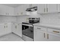 Bright kitchen with white cabinets, stainless steel appliances, and subway tile backsplash at 5429 W Kerry Ln, Glendale, AZ 85308