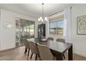 Dining room with a dark wood table, six chairs, and sliding glass doors at 5629 S Veneto --, Mesa, AZ 85212