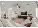 Bright living room with sectional sofa, wood floors, and a view of the stairs at 5629 S Veneto --, Mesa, AZ 85212