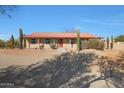 House exterior showcasing a red door and cacti at 5820 E Morning Vista Ln, Cave Creek, AZ 85331