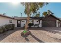 Single story home with a large driveway and mature trees at 6409 W Orange Dr, Glendale, AZ 85301