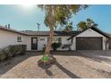 Charming home showcasing a welcoming front yard and a well-maintained exterior with brick driveway at 6409 W Orange Dr, Glendale, AZ 85301