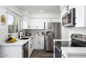 Modern kitchen with white shaker cabinets, stainless steel appliances, and quartz countertops at 725 E Vaughn Dr, Tempe, AZ 85283