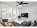 Cozy living room features a leather sofa, coffee table, and ceiling fan at 725 E Vaughn Dr, Tempe, AZ 85283