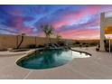 Relaxing kidney-shaped pool with a waterfall feature at 7409 W Briles Rd, Peoria, AZ 85383