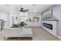 Open concept living room featuring a fireplace and built-in shelving at 7749 E Coolidge St, Scottsdale, AZ 85251