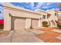 Two-car garage with tiled driveway and landscaping at 7800 E Lincoln Dr # 1096, Scottsdale, AZ 85250