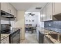 Kitchen features granite countertops, gray cabinets, and stainless steel appliances at 8225 N 34Th Dr, Phoenix, AZ 85051