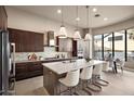 Modern kitchen with a large island, stainless steel appliances, and white quartz countertops at 8260 E Mohawk Ln, Scottsdale, AZ 85255