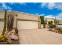 Front view of a house with a garage and xeriscaping at 8438 N 84Th Pl, Scottsdale, AZ 85258