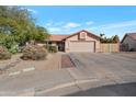 Charming single-story home with a two-car garage and well-maintained landscaping at 859 N 54Th Cir, Mesa, AZ 85205