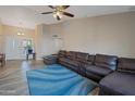 Spacious living room featuring a large sectional sofa and a calming blue rug at 859 N 54Th Cir, Mesa, AZ 85205