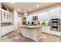 Island kitchen with white cabinets and granite countertops at 9270 E Thompson Peak Pkwy # 335, Scottsdale, AZ 85255