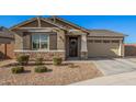 Single-story home with neutral exterior, two-car garage, and landscaping at 9316 S 39Th Dr, Laveen, AZ 85339