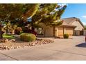 Home's side view, highlighting garage and landscaping at 9613 W Camino De Oro Dr, Peoria, AZ 85383