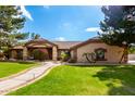 House exterior with manicured lawn and walkway at 9613 W Camino De Oro Dr, Peoria, AZ 85383