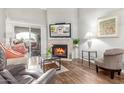 Living room features a fireplace, hardwood floors, and a view to patio at 10401 N 52Nd St # 208, Paradise Valley, AZ 85253