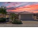 One-story house with terracotta tile roof at sunset at 15113 W Cactus Ridge Way, Surprise, AZ 85374