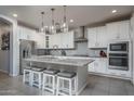 Spacious kitchen with white cabinets, granite countertops, and an island at 15282 W Mckinley St, Goodyear, AZ 85338