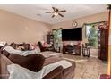 Cozy living room featuring a large sectional sofa and flat-screen TV at 1819 W Magdalena Ln, Phoenix, AZ 85041