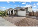 Gray house with a large driveway and a modern design at 21123 E Mayberry Rd, Queen Creek, AZ 85142