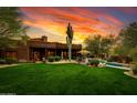 Landscaped backyard with pool and sunset view at 25555 N Wrangler Rd, Scottsdale, AZ 85255