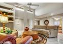 Spacious living room featuring a large sofa and tile floors at 25836 N Primo Cir, Rio Verde, AZ 85263