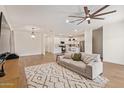 Open living room with a neutral color scheme and access to the kitchen at 35321 W Santa Monica Ave, Maricopa, AZ 85138