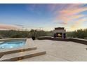 Relaxing hot tub with a fireplace and beautiful desert views at 36549 N Porta Nuova Rd, Scottsdale, AZ 85262