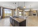 Gourmet kitchen with granite countertops and dark wood cabinets at 36549 N Porta Nuova Rd, Scottsdale, AZ 85262