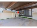 Covered carport with wood slat accents and artificial turf at 8642 E Monterosa Ave, Scottsdale, AZ 85251