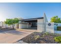 Mid-century home with carport, and landscaped yard at 8642 E Monterosa Ave, Scottsdale, AZ 85251