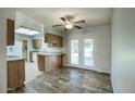 Kitchen boasts wood cabinets, tile flooring, and access to backyard patio at 9841 N Balboa Dr, Sun City, AZ 85351