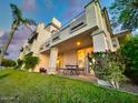 Two-story home with patio, lush landscaping, and lake views at 10080 E Mountain View Lake Dr # 140, Scottsdale, AZ 85258