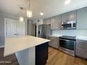 Modern kitchen with stainless steel appliances and an island at 10080 E Mountain View Lake Dr # 140, Scottsdale, AZ 85258