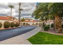 Landscaped entrance to a community with palm trees at 10080 E Mountainview Lake Dr # 242, Scottsdale, AZ 85258